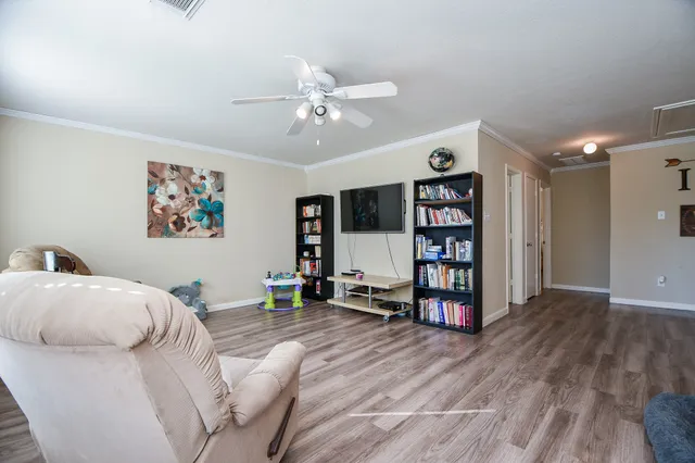a living room with furniture and wooden floor