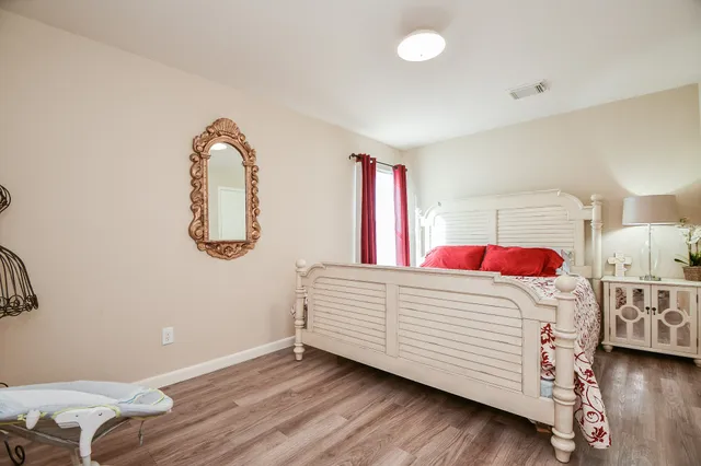 a bedroom with a bed and a dresser