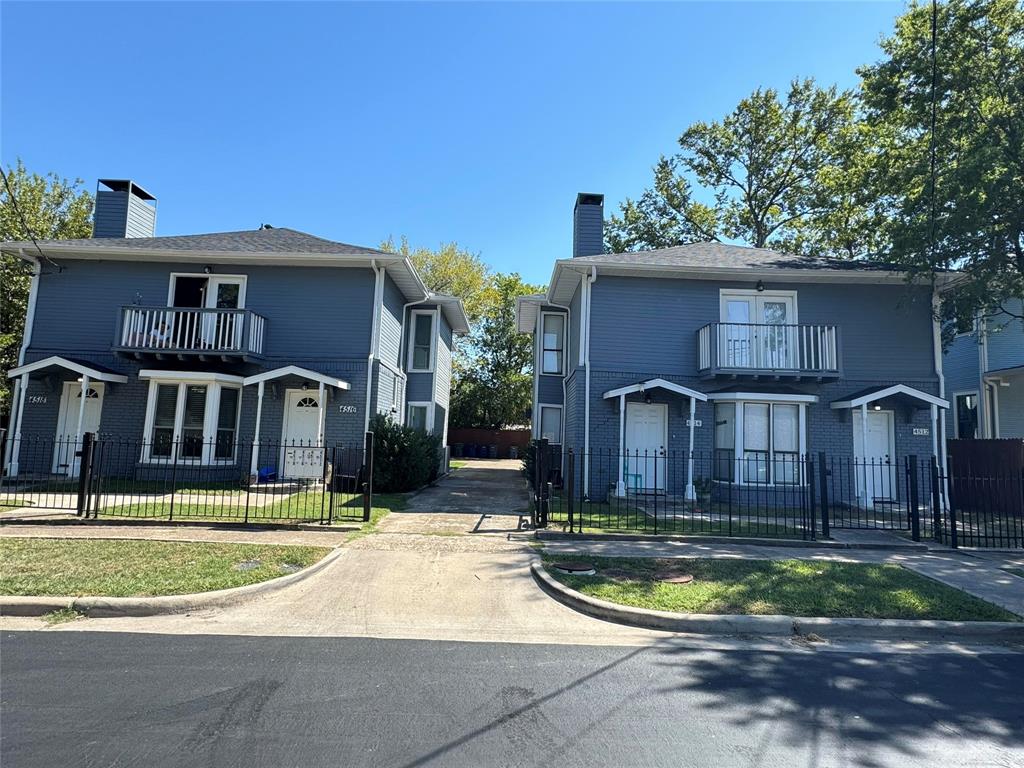 4512 Sycamore Street Dallas, TX 75204 - Photo 1 of 23 View of front facade featuring a balcony, a chimney, and a fenced front yard