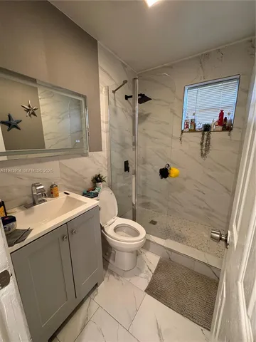 a bathroom with a sink toilet and shower