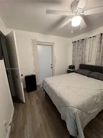 a bedroom with a bed and a flat tv screen