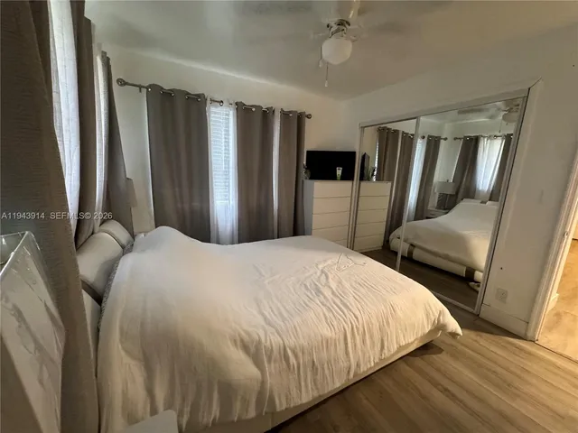 a bedroom with furniture and a flat screen tv