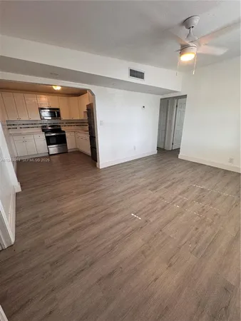 a view of a room with wooden floor