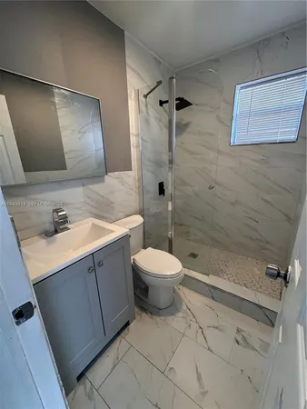 a bathroom with a toilet and a shower