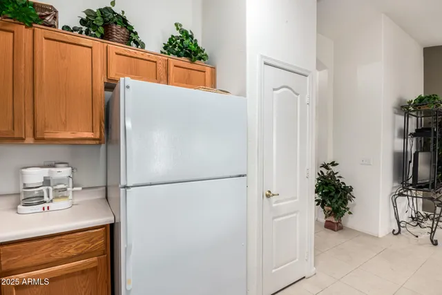 a white refrigerator freezer sitting in a kitchen