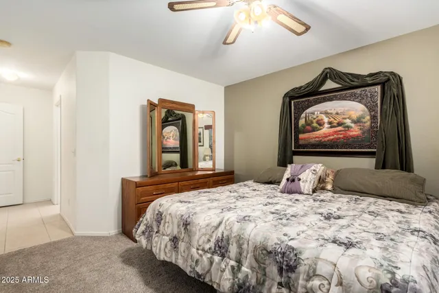 a bedroom with a bed and a painting on the wall