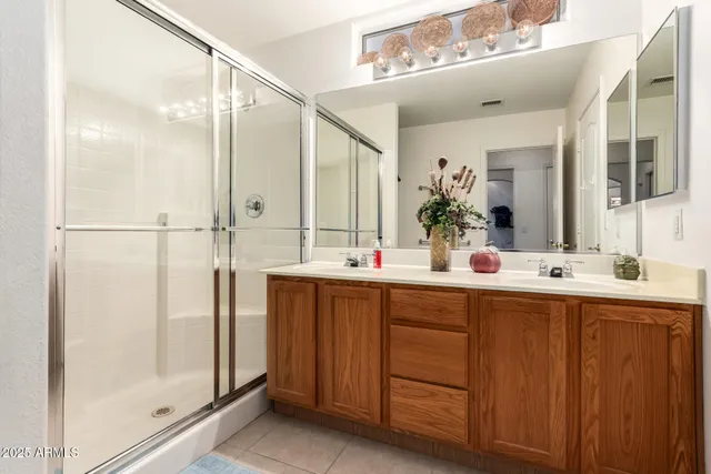 a bathroom with a double vanity sink and a mirror