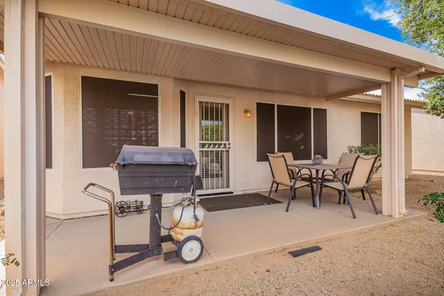 a view of a patio with a table and chairs