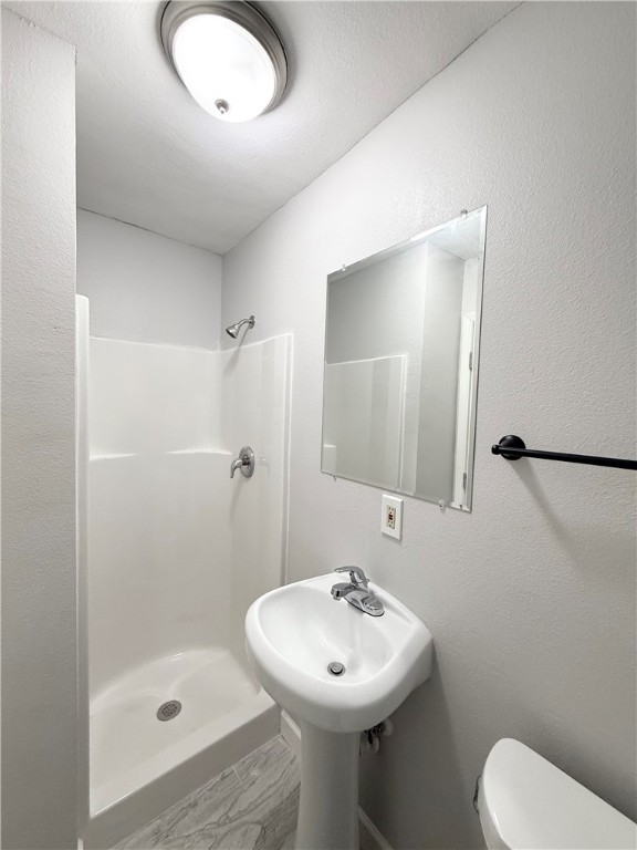 4814 Easter Drive Corpus Christi, TX 78415 - Photo 15 of 19 a bathroom with a sink toilet and shower