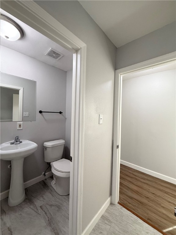 4814 Easter Drive Corpus Christi, TX 78415 - Photo 16 of 19 a bathroom with a toilet a sink and mirror