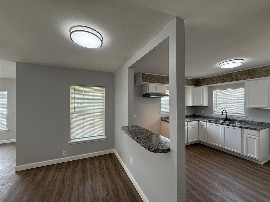 4814 Easter Drive Corpus Christi, TX 78415 - Photo 6 of 19 a kitchen with granite countertop a sink cabinets stainless steel appliances and a window