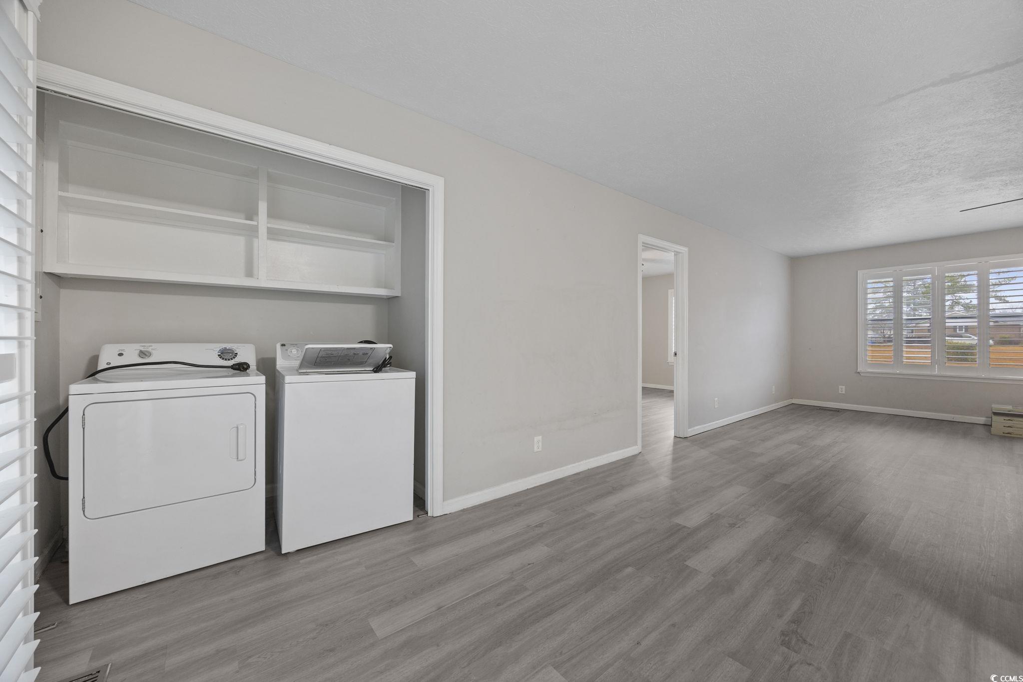 5180 Graham Street Loris, SC 29569 - Photo 11 of 28 Laundry area featuring separate washer and dryer, wood finished floors, and a textured ceiling
