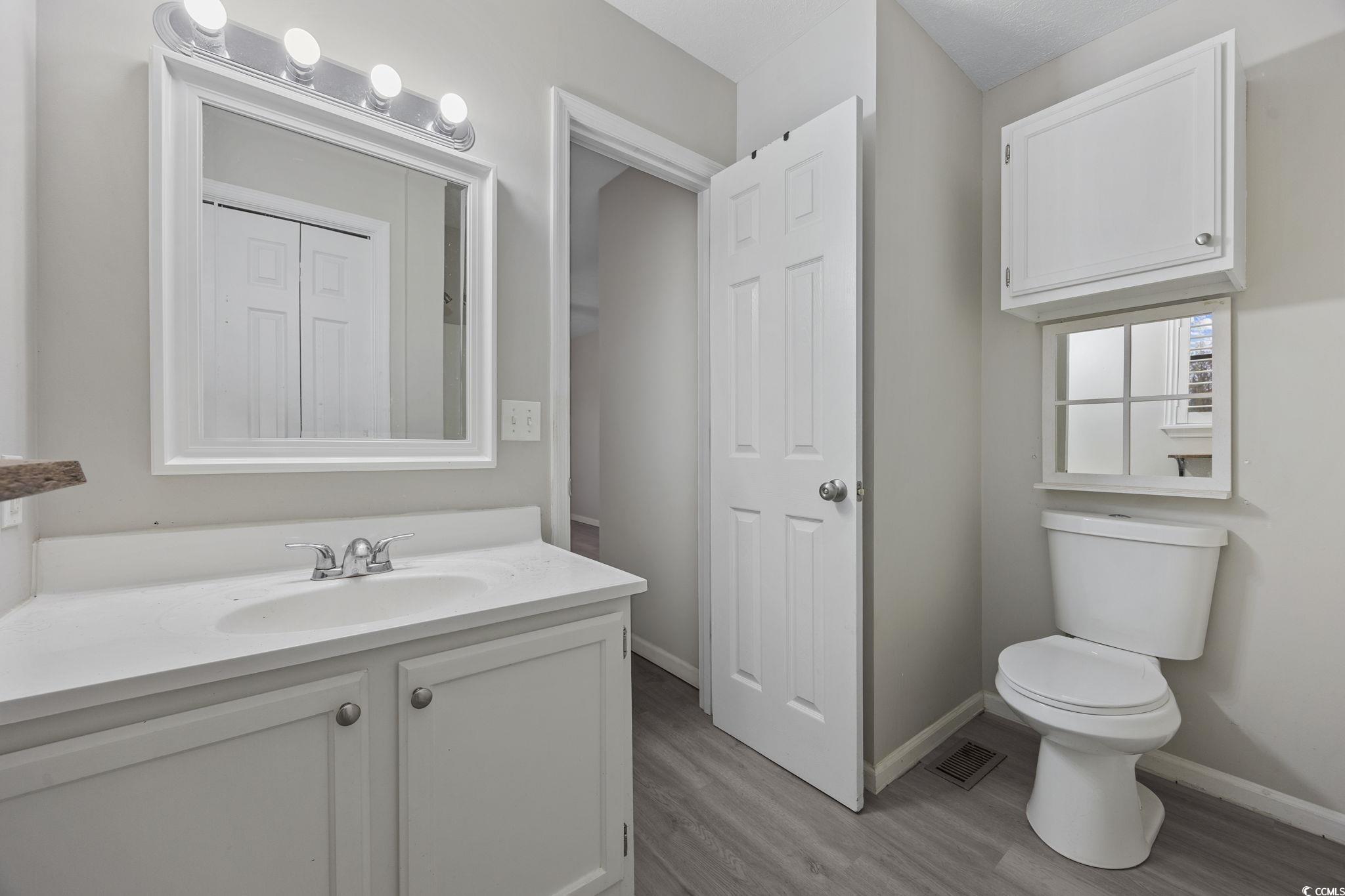 5180 Graham Street Loris, SC 29569 - Photo 15 of 28 Half bath with vanity and light wood finished floors