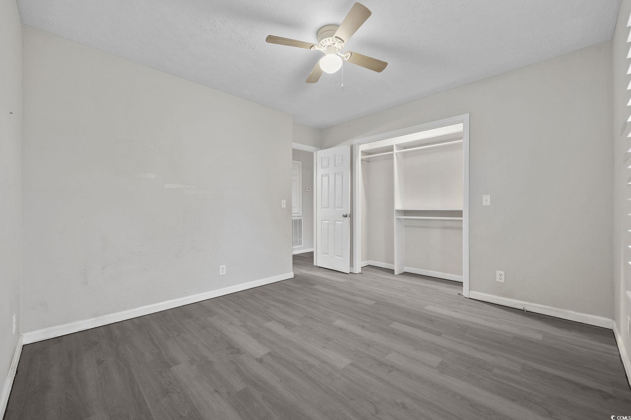 5180 Graham Street Loris, SC 29569 - Photo 18 of 28 Spare room featuring wood finished floors, ceiling fan, and a textured ceiling