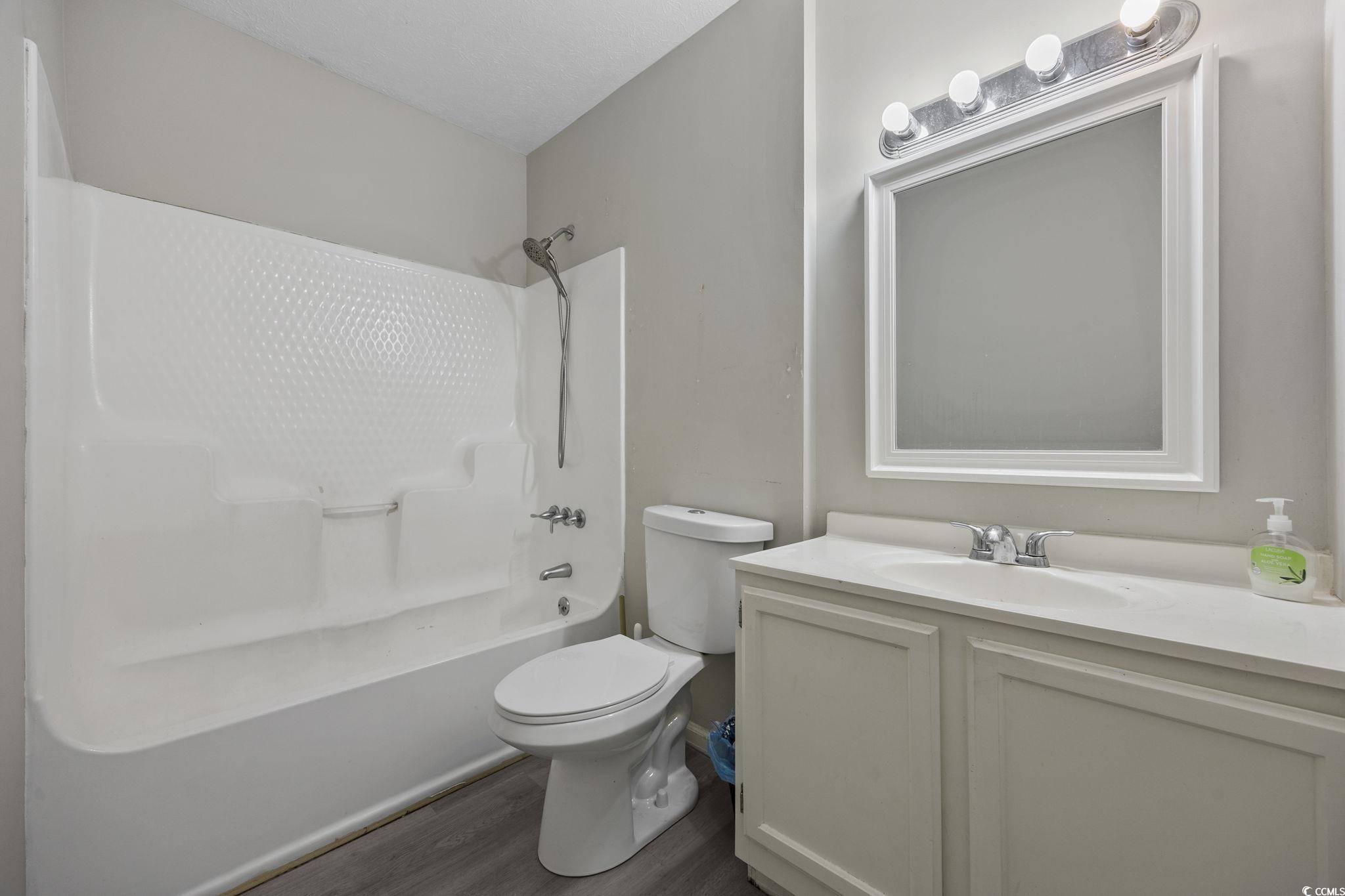 5180 Graham Street Loris, SC 29569 - Photo 19 of 28 Unfurnished bedroom with wood finished floors, a ceiling fan, and a closet