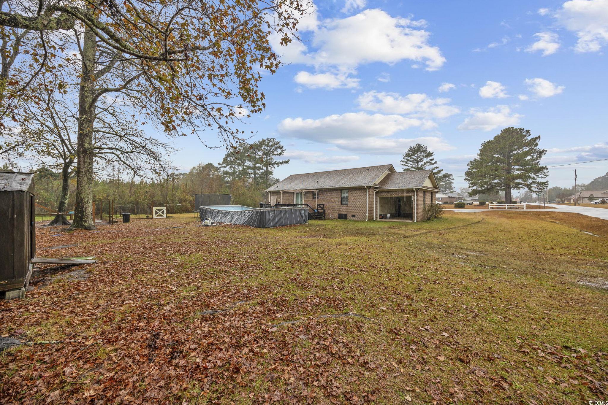 5180 Graham Street Loris, SC 29569 - Photo 25 of 28 Wooden terrace featuring a trampoline and an outdoor pool