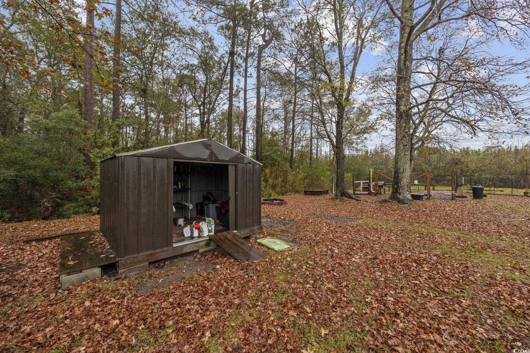 5180 Graham Street Loris, SC 29569 - Photo 26 of 28 View of grassy yard with a covered pool and a wooden deck