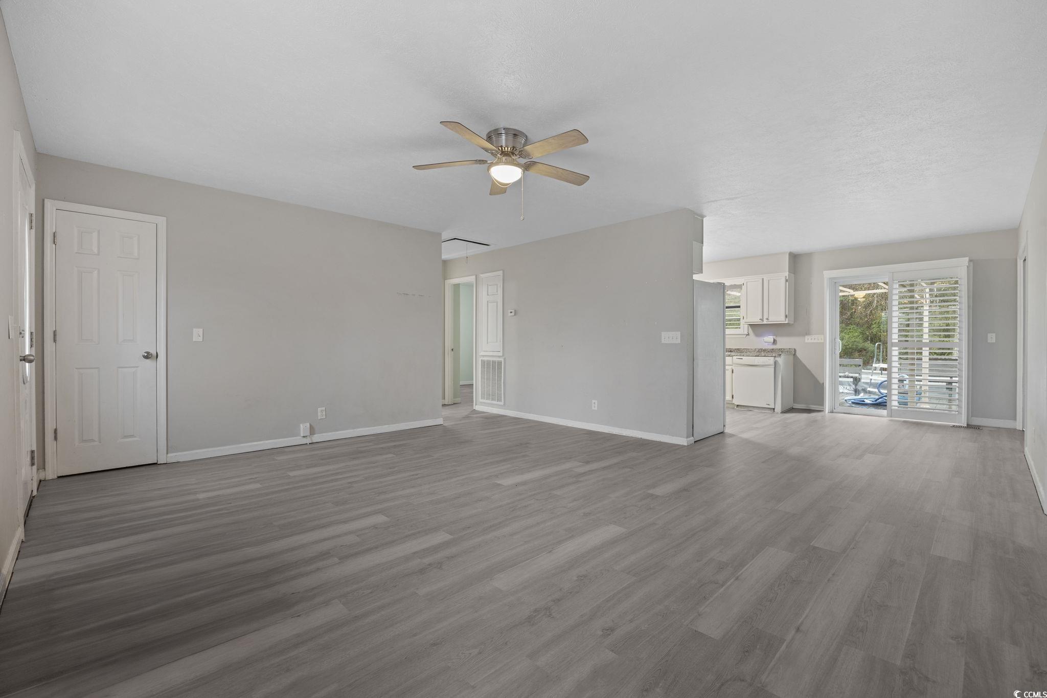 5180 Graham Street Loris, SC 29569 - Photo 5 of 28 Unfurnished living room featuring wood finished floors and ceiling fan