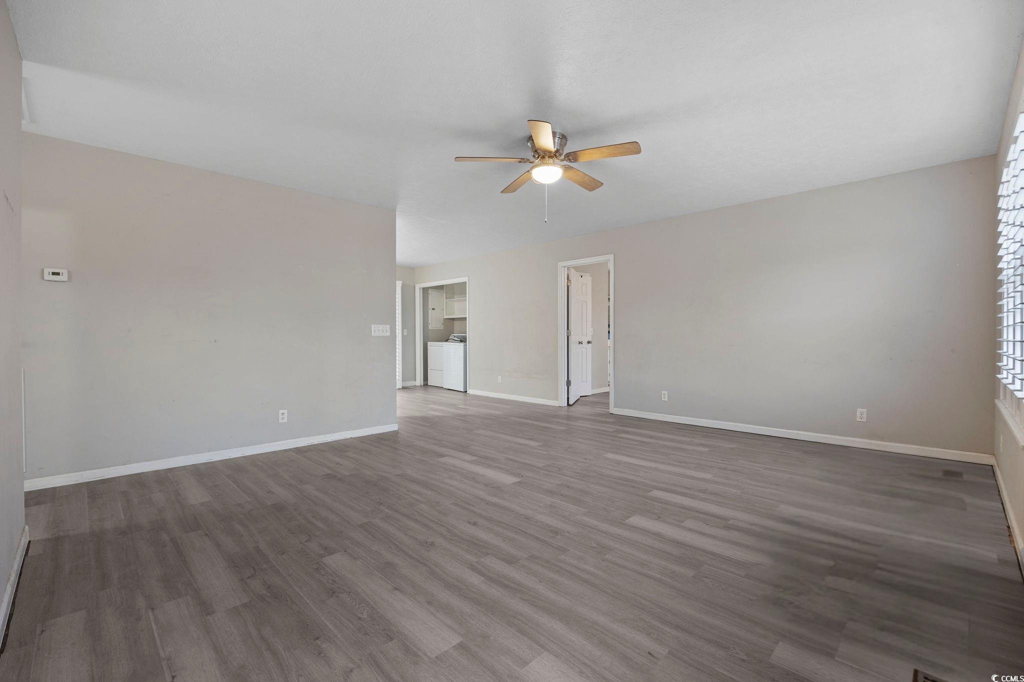 5180 Graham Street Loris, SC 29569 - Photo 6 of 28 Empty room featuring dark wood-type flooring, ceiling fan, and washer / clothes dryer