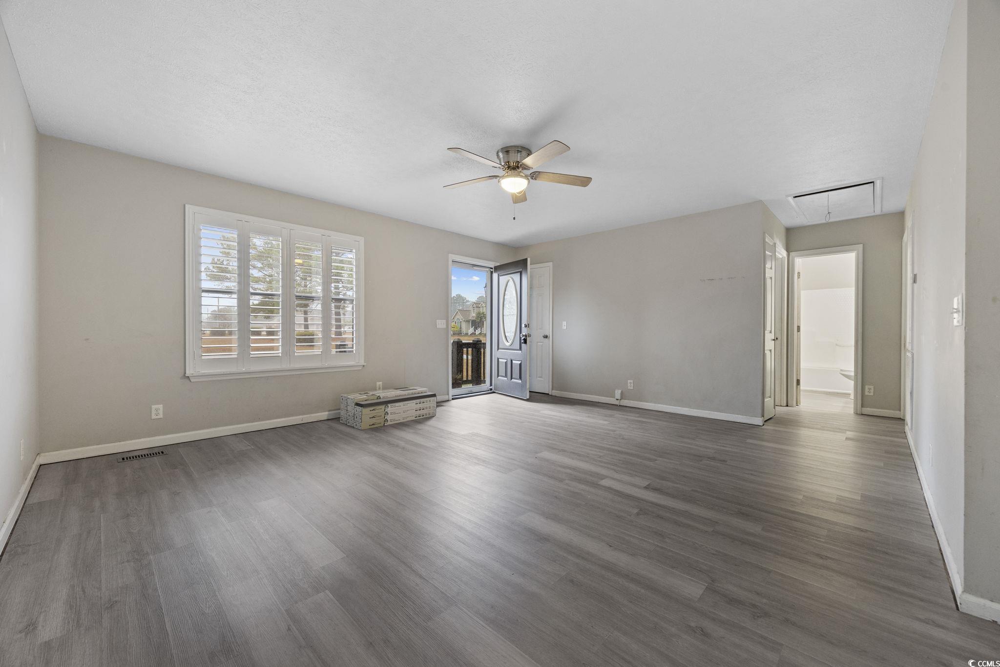 5180 Graham Street Loris, SC 29569 - Photo 8 of 28 Unfurnished living room featuring attic access, dark wood-type flooring, and ceiling fan