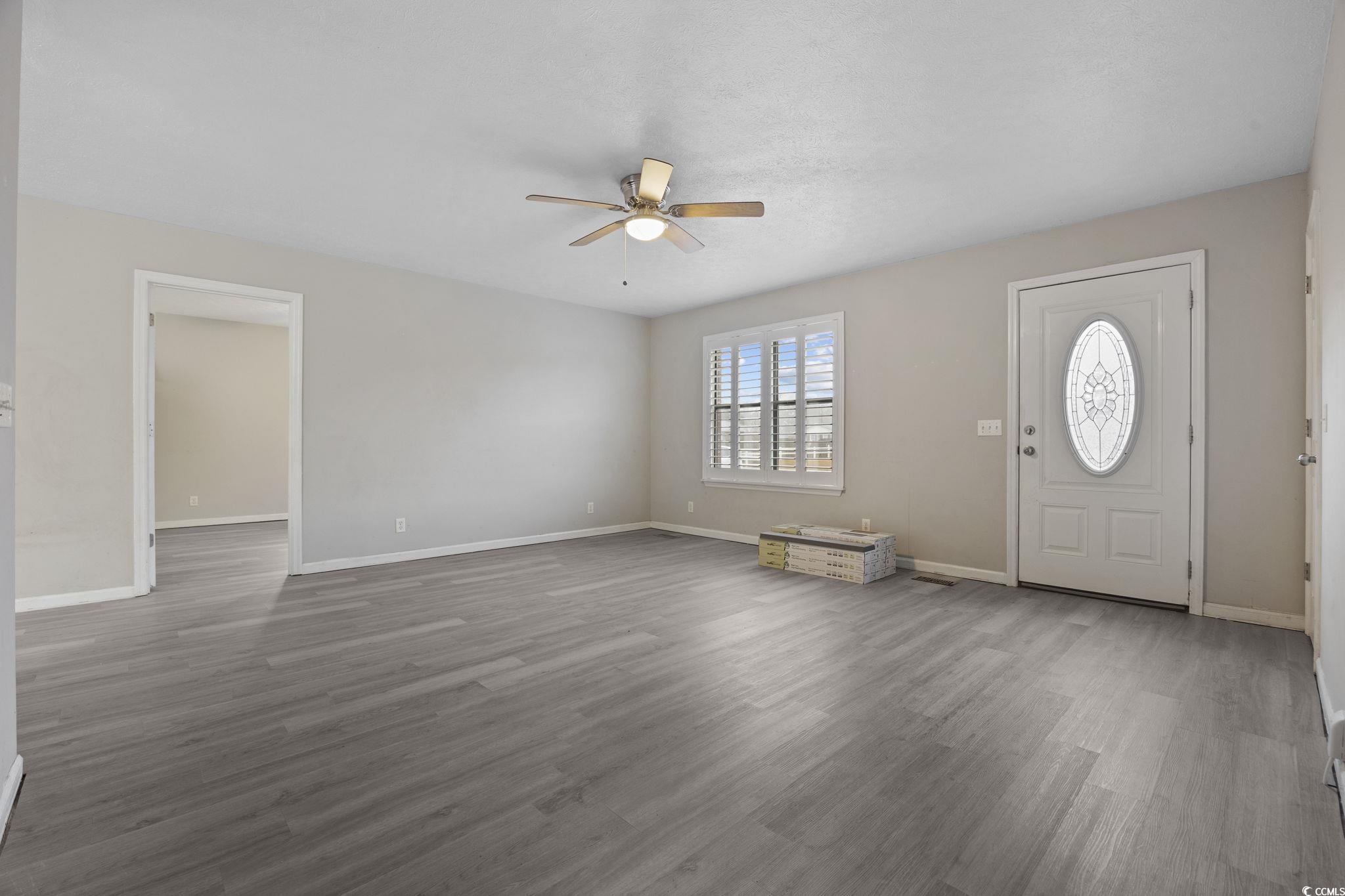 5180 Graham Street Loris, SC 29569 - Photo 9 of 28 Foyer entrance featuring light wood-style flooring and ceiling fan