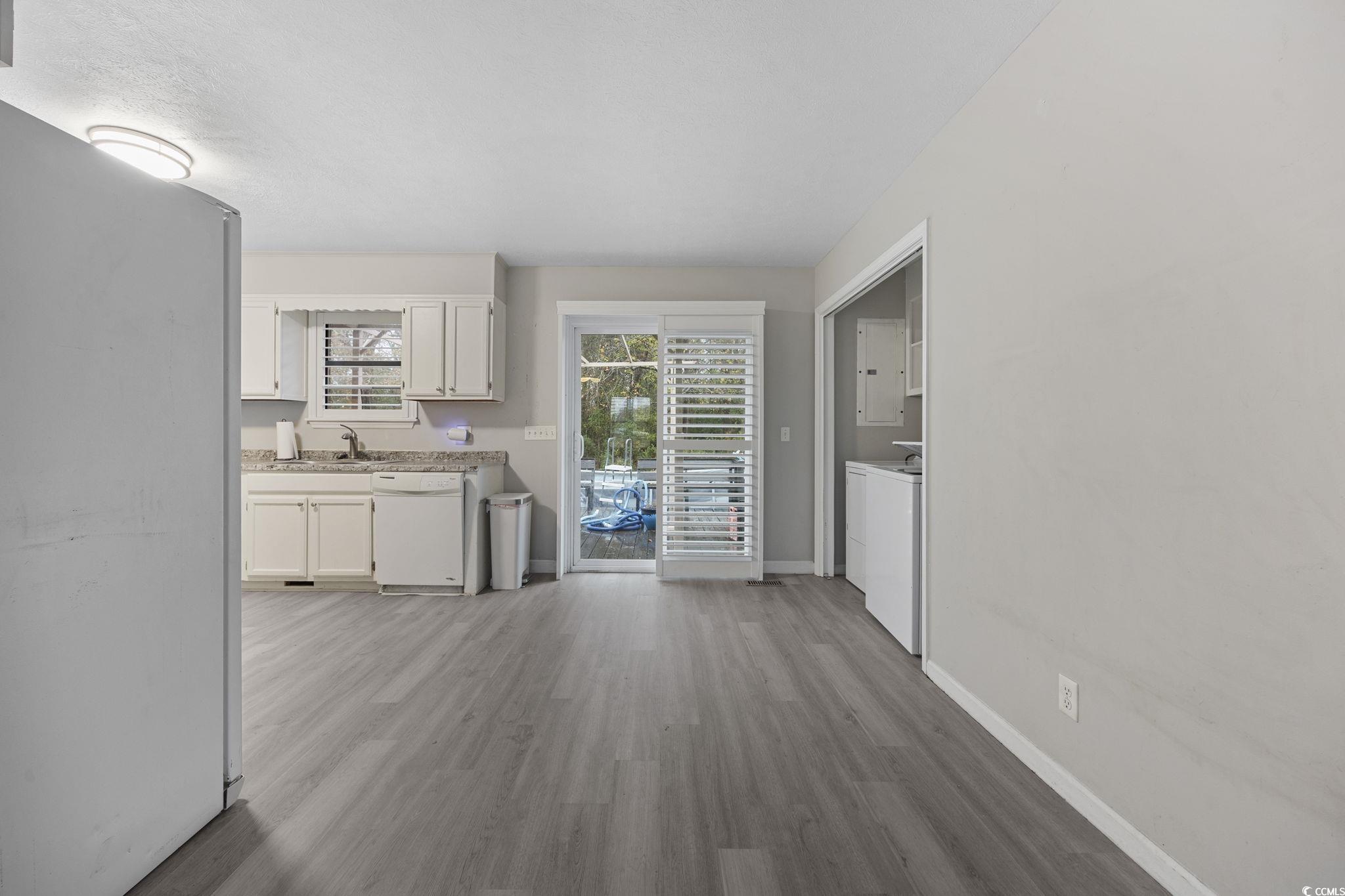 5180 Graham Street Loris, SC 29569 - Photo 10 of 28 Kitchen with white appliances, white cabinetry, and light wood-style floors