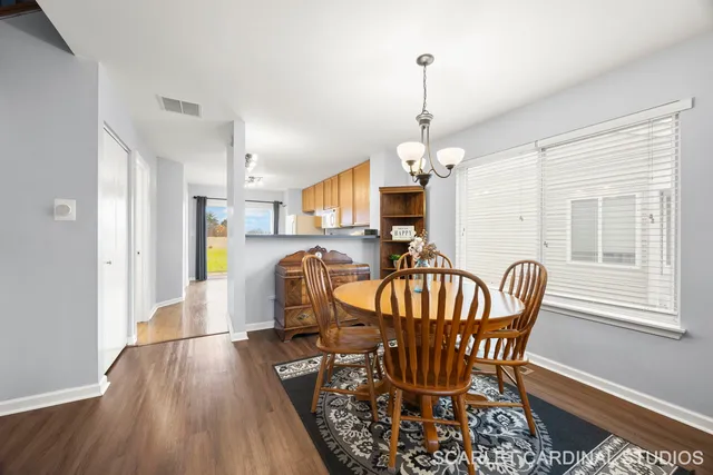 a view of a dining room with furniture window and wooden floor