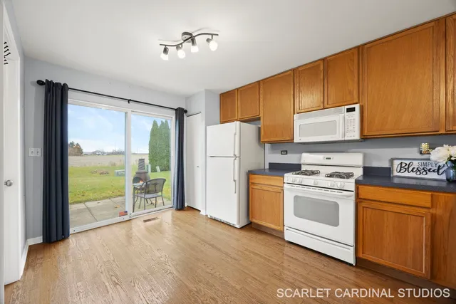 a kitchen with a stove a refrigerator and a sink