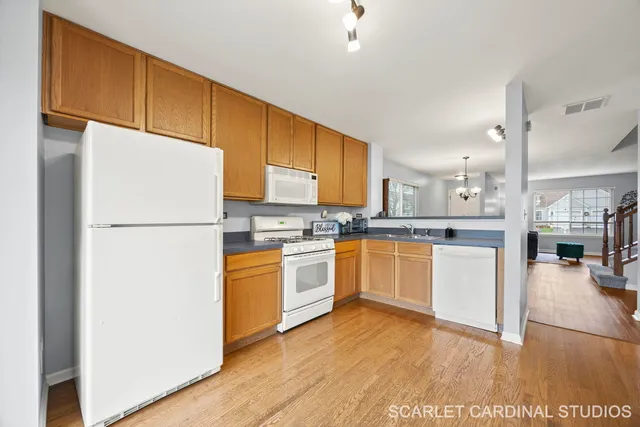 a kitchen with white cabinets and white appliances