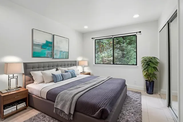 a bedroom with bed and a window