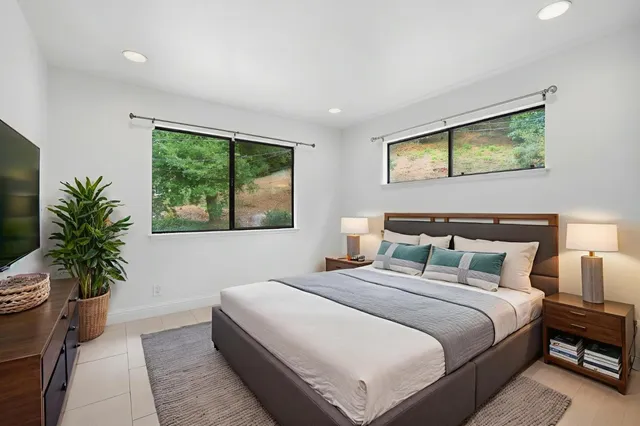 a bedroom with bed and a potted plant