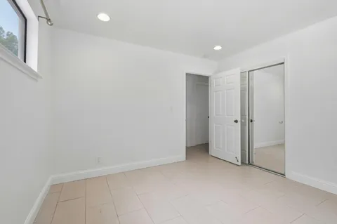 a bedroom with a bed and a potted plant