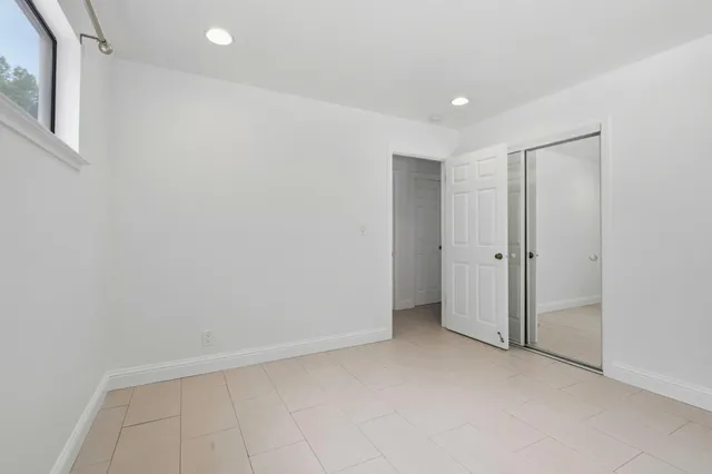 a bedroom with a bed and a potted plant