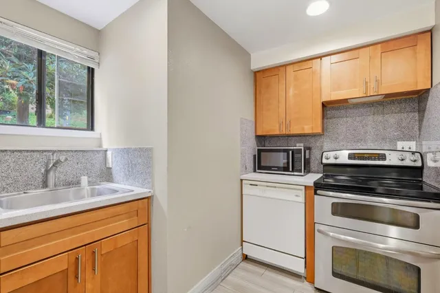 a bedroom with a bed lamp and a large window