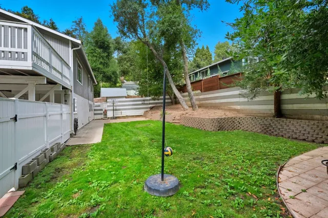 a view of backyard with table and chairs and potted plants