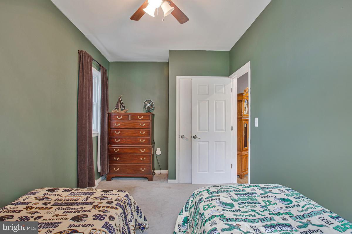 976 Shore Acres Road Arnold, MD 21012 - Photo 27 of 40 a bedroom with a bed and a dresser