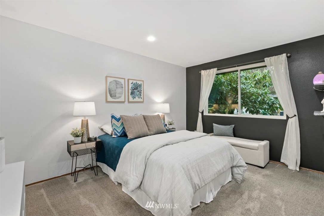 5624 227th Street Southeast Bothell, WA 98021 - Photo 12 of 24 a bedroom with a large bed and a large window