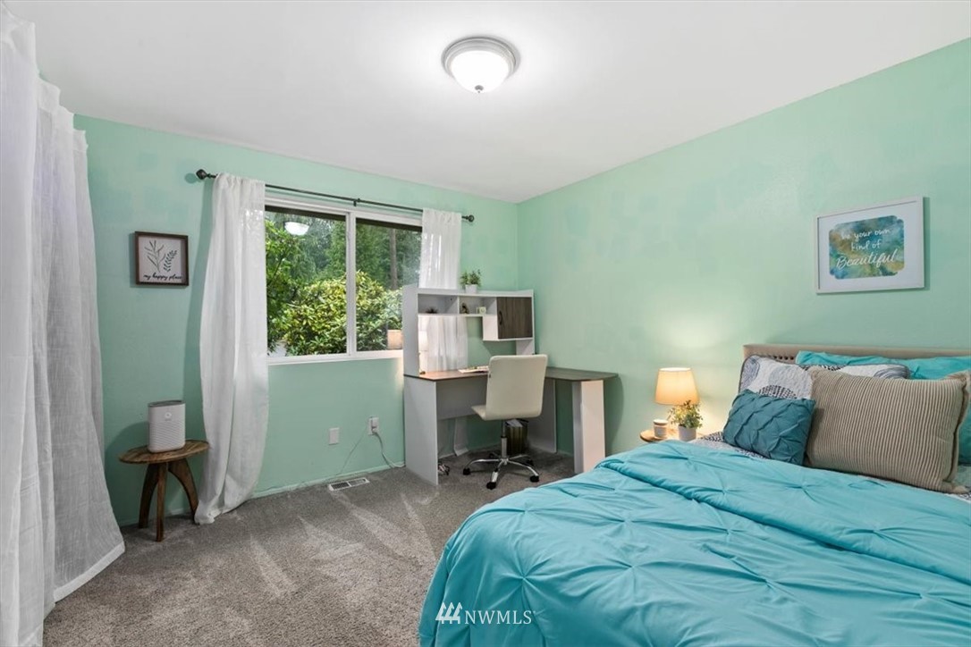 5624 227th Street Southeast Bothell, WA 98021 - Photo 13 of 24 a bed sitting in a bedroom next to a window