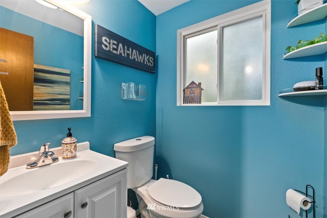 5624 227th Street Southeast Bothell, WA 98021 - Photo 16 of 24 a bathroom with a toilet a sink and mirror