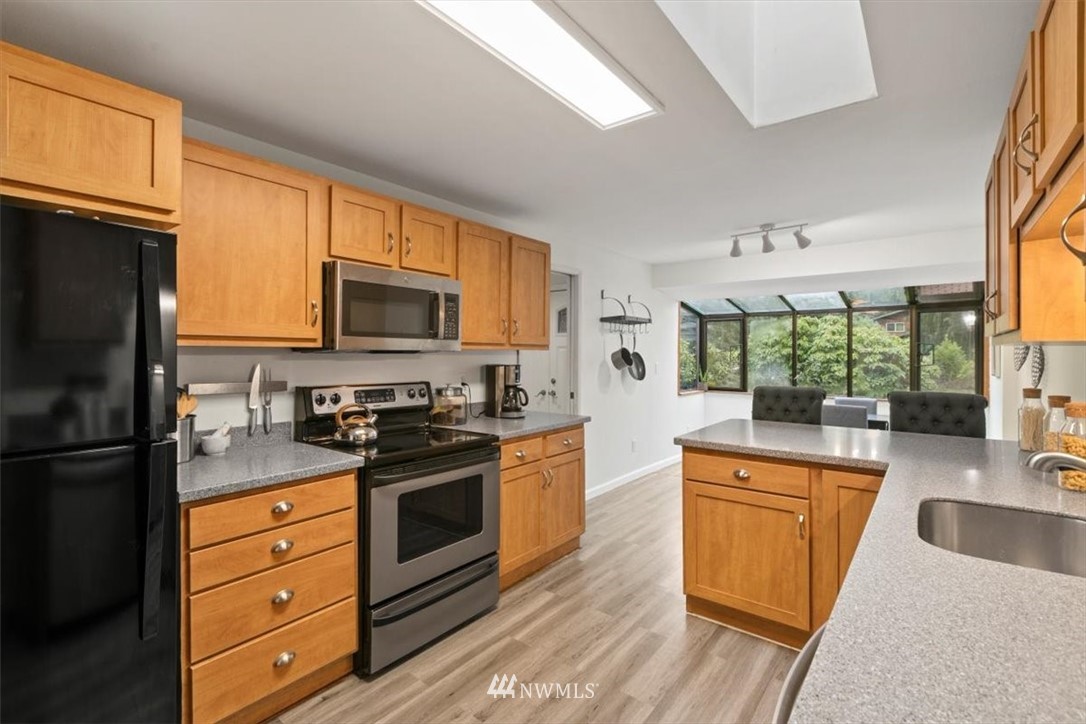 5624 227th Street Southeast Bothell, WA 98021 - Photo 17 of 24 a kitchen with granite countertop a sink stainless steel appliances and cabinets