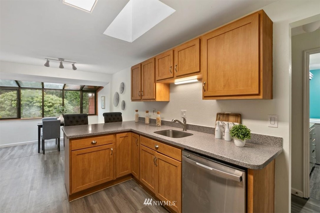 5624 227th Street Southeast Bothell, WA 98021 - Photo 18 of 24 a kitchen with a sink a window and cabinets