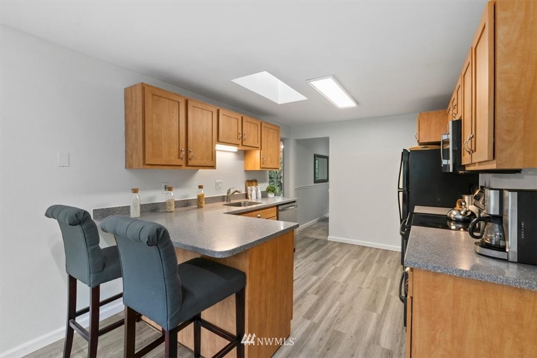5624 227th Street Southeast Bothell, WA 98021 - Photo 19 of 24 a view of a dining room with furniture and wooden floor