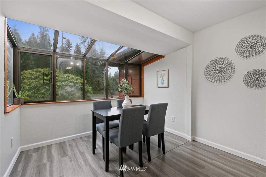 5624 227th Street Southeast Bothell, WA 98021 - Photo 20 of 24 a view of a dining room with furniture window and wooden floor
