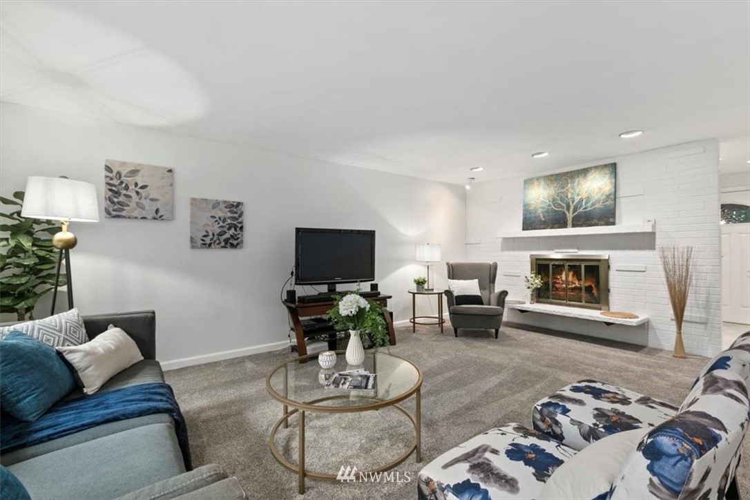 5624 227th Street Southeast Bothell, WA 98021 - Photo 4 of 24 a living room with furniture a fireplace and a flat screen tv