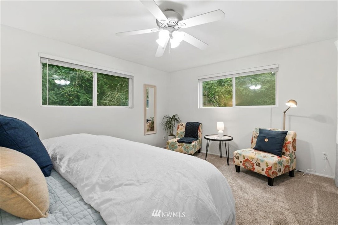 5624 227th Street Southeast Bothell, WA 98021 - Photo 8 of 24 a bedroom with a bed and a chandelier