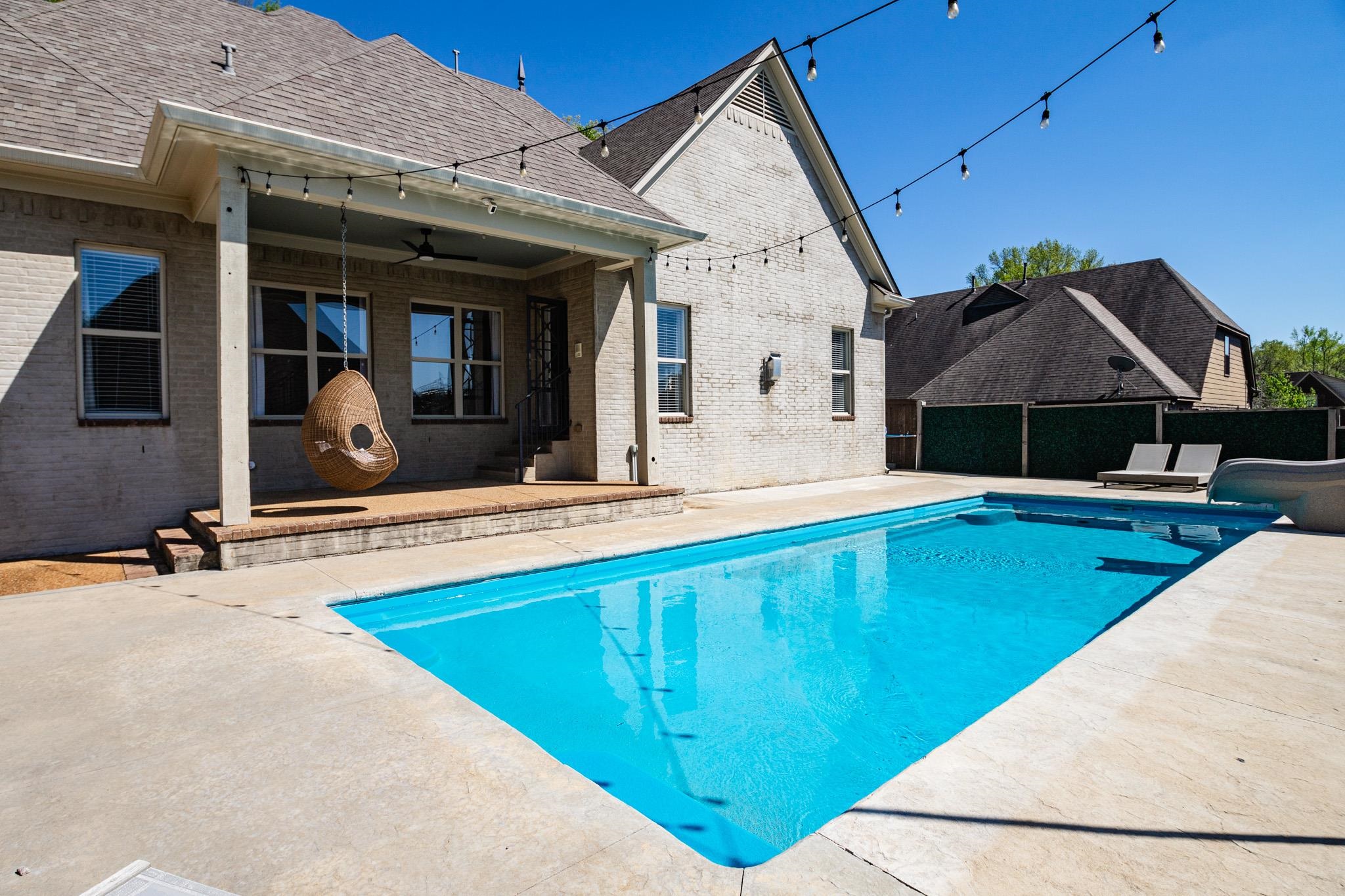 5309 Evergreen Road Lakeland, TN 38002 - Photo 5 of 40 View of pool featuring a fenced in pool, a patio, a water slide, ceiling fan, and fence