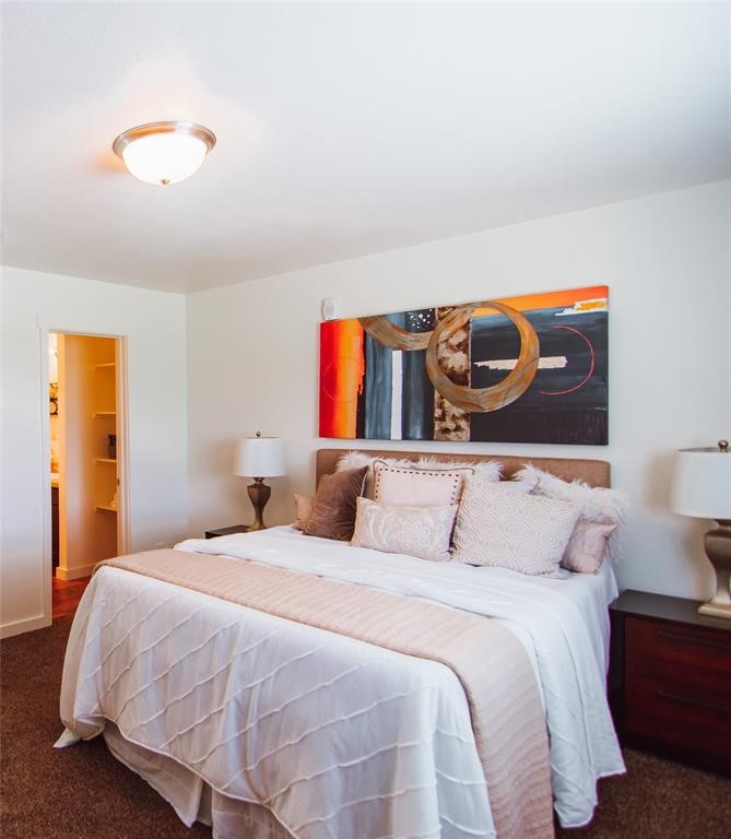 12603 Telge Road, Unit 4B Cypress, TX 77429 - Photo 5 of 16 a bedroom with a bed and a painting on the wall