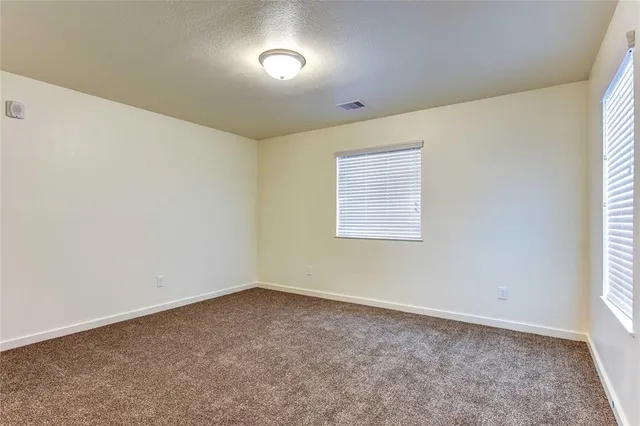 an empty room with a empty space and windows