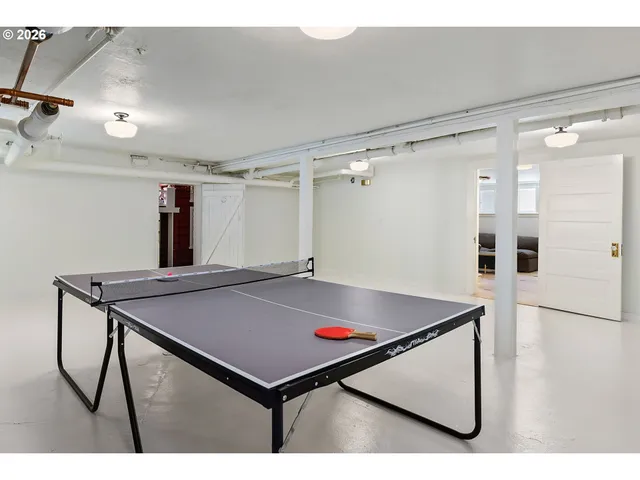 a room with pool table and window
