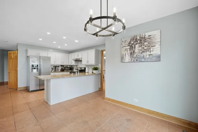 a open kitchen with cabinets and stainless steel appliances